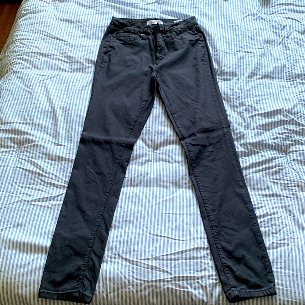 Gray high rise skinny jeans.